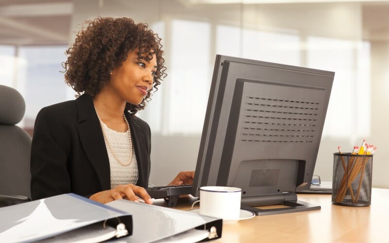 Woman staring intently at computer screen